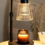 Candle warmer lamp on a bedside table creating a warm and cozy home decor atmosphere.