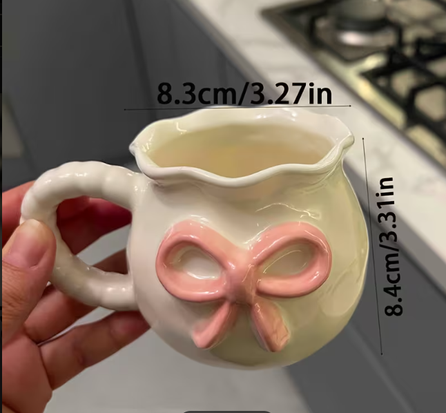 Cute bow ceramic mug in soft pastel kitchen styling